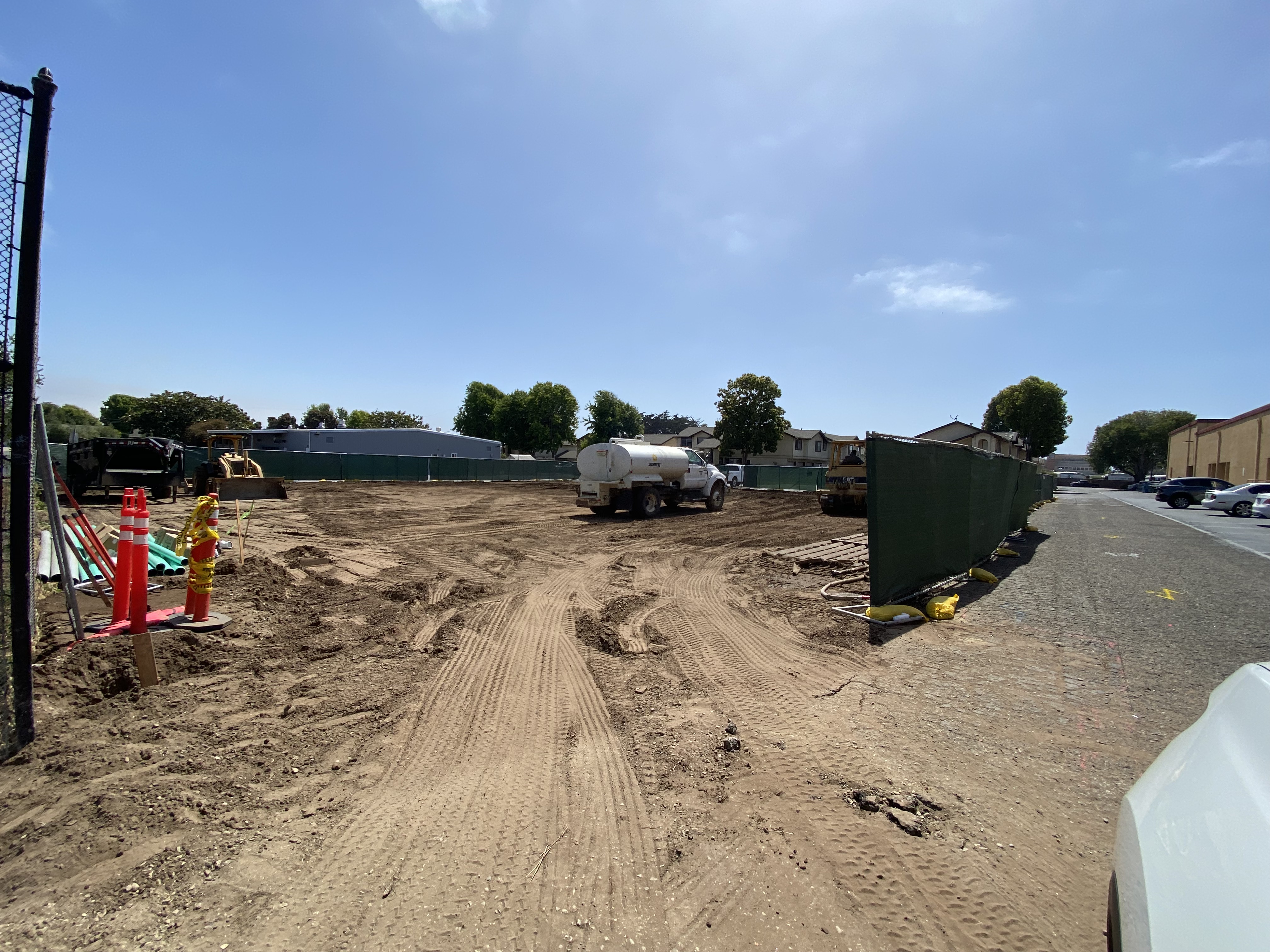 construction truck on the dirt lot site that will become the cabin shelter project facility